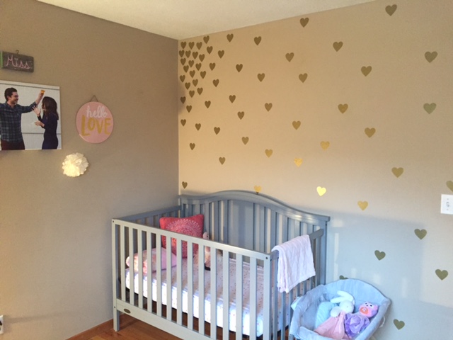 baby girl nursery with gold heart decals